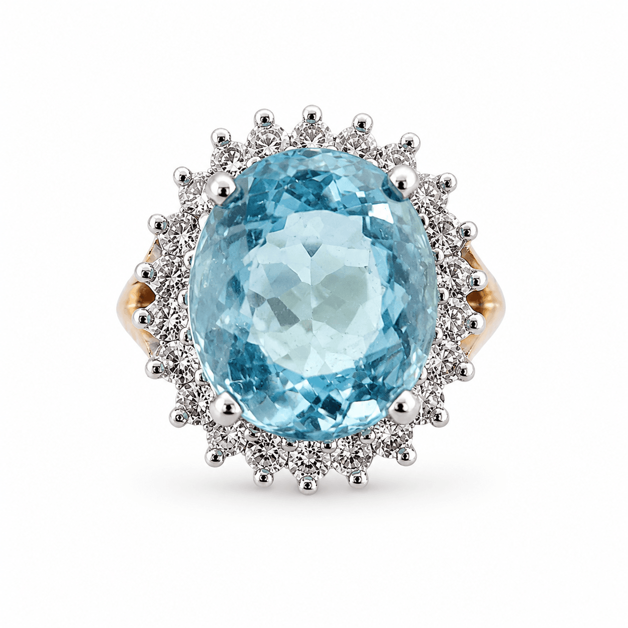Oval aquamarine and diamond halo ring shown from above in 14k yellow gold with white gold head