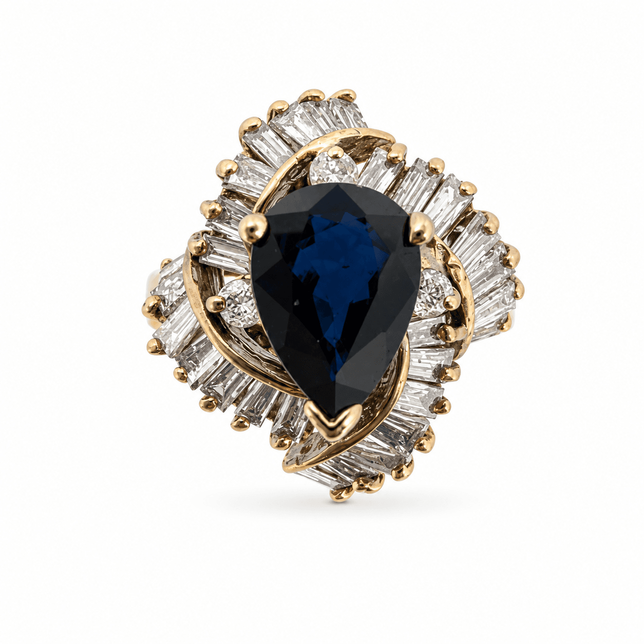 14K yellow gold sapphire ring showing pear-shape blue sapphire center stone with baguette diamond halo, top view