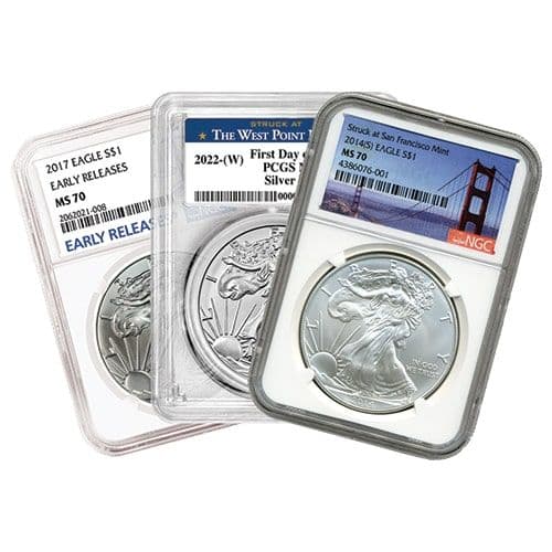 Three MS70-graded American Silver Eagle slabs from PCGS and NGC showing 2014(S), 2017, and 2022-(W) label varieties